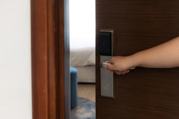 Female hand opening hotel room. Concept about lifestyle, travel, people and tourism.