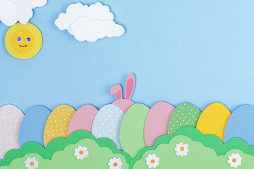 Fototapeta na wymiar Pink Bunny rabbit ears and painted Easter eggs made of paper. Happy Easter background with bunny hide in grass. Easter greeting card template. Creative easter minimal concept with copy space Flat lay