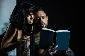 Sexy couple reading book. Romantic lovely coupl in love, sexy boyfriend and beautiful girlfriend....