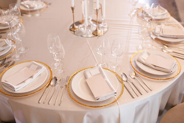 Tables setting at a luxury wedding. Table for guests. Dishes and drinks. Wedding table preparation.