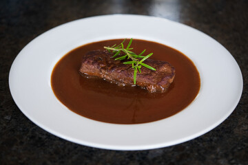 ready to eat, grilled game meat from the roe deer with brown sauce and rosemary