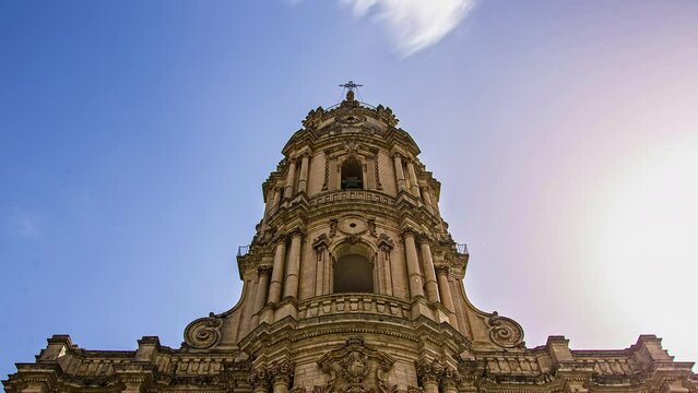 Timelapse shot of flying clouds behind Dome of St. George, a Baroque church located in Ragusa Ibla, Sicily, Italy.