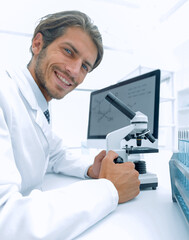 Student in biology using microscope in training class