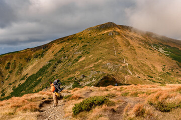 Fototapeta premium Adventure lifestyle, travel in the mountains with a backpack and overnight.