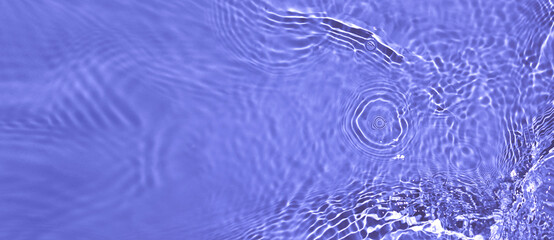 Transparent purple clear water surface texture with ripples and splashes. Abstract summer banner...