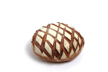 Loaf black rye bread sprinkled with flour, on a white background.