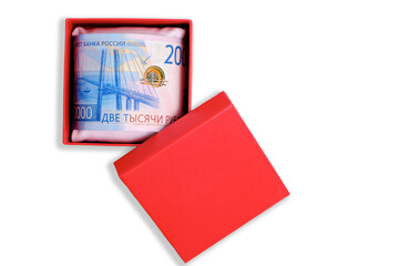 Russia banknote with face value two thousand rubles in red gift box white background.