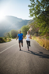 Were in it for the long run. Shot of a sporty couple out running on a mountain road.