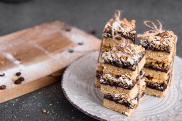 Cookies on a white plate. Baking on a gray table. The wooden board is on the table.
