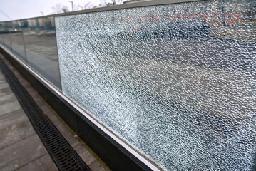 Broken glass fence, damaged glass panel with banisters. Broken guard rail on office terrace. Steel...