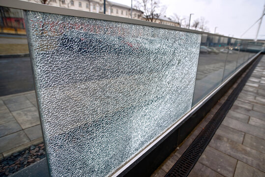 Broken Glass Fence. Damaged Glass Fence With Banisters. Broken Guard Rail On Office Terrace. Steel Railing With Glass Panel, Cracks On Broken Tempered Glass. Vandalism Concept