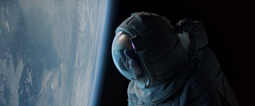 CU Portrait of Caucasian female astronaut during spacewalk on the Earth orbit. Space exploration, Mars mission. Shot with 2x anamorphic lens