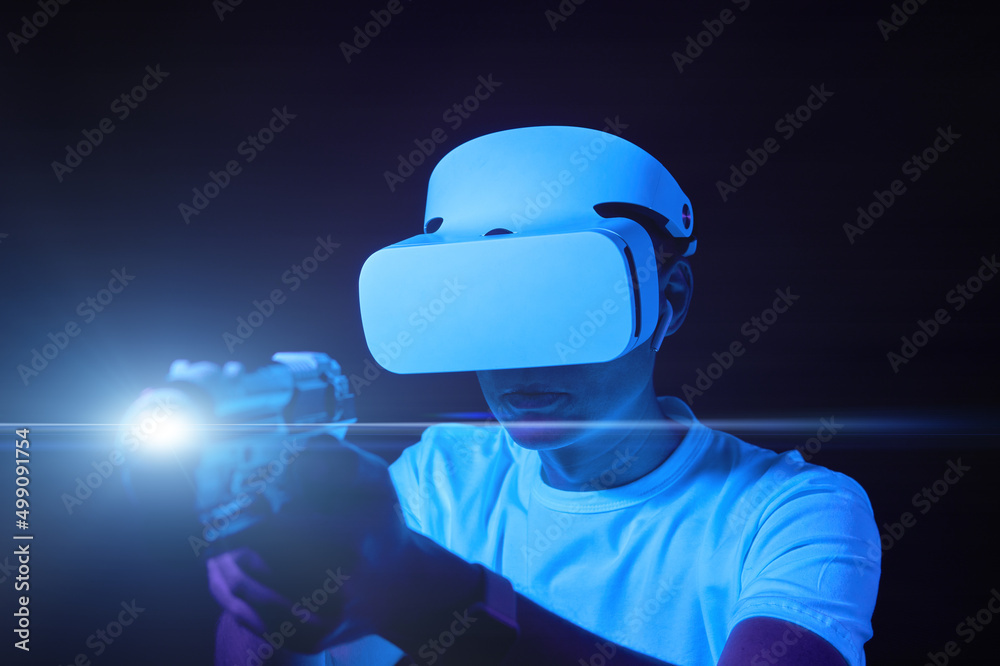 Wall mural man with virtual reality headset is playing game.