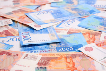 Background, Russian rubles banknotes in denominations of two and five thousand rubles.