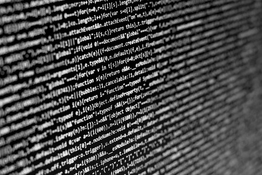 Software developer does the coding. Black and white Abstract screen for use as a background. The Programmer typing web code