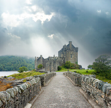 Scenic view of medieval castle in Scotland Eilean Donan under cloudy sky