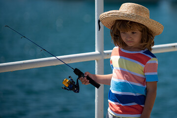 Child boy engaged in fishing hobbies, holds a fishing rod. Summer children lifestyle. Kids fishing on weekend,