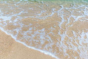Fototapeta na wymiar Golden sand and clear water of a beach on Koh Chang island in Thailand