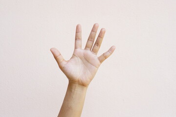 Asian woman's hand gray background