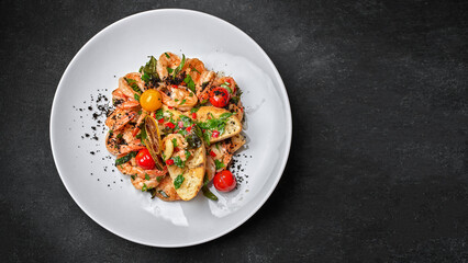 Fried shrimp with toast and tomatoes, on a plate, on a dark background with space for text