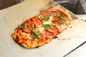 Delicious pizza served on wooden plate. Concept for advertising flyer and poster for restaurants or pizzerias, template with delicious taste of pepperoni.