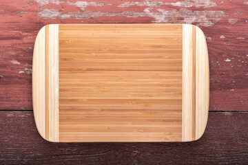 Empty cutting board on a wooden background. Top view.