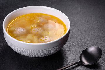 Soup with turkey meatballs, potatoes and vegetables. Selective focus