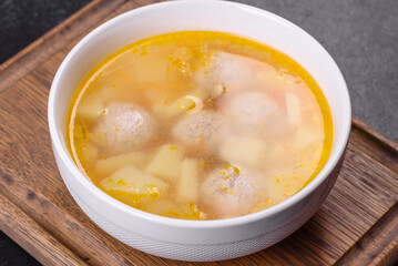 Soup with turkey meatballs, potatoes and vegetables. Selective focus