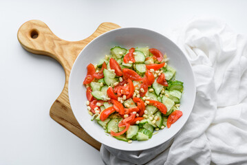 A delicious salad with beans, tomatoes and cucumbers on a white background