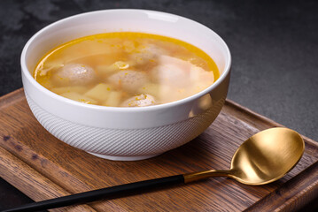 Soup with turkey meatballs, potatoes and vegetables. Selective focus