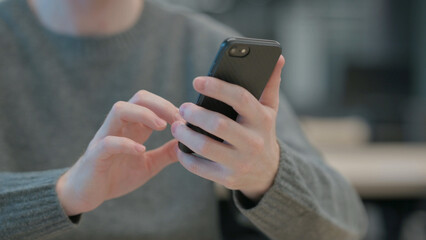 Close up of Hands of Man using Smartphone 