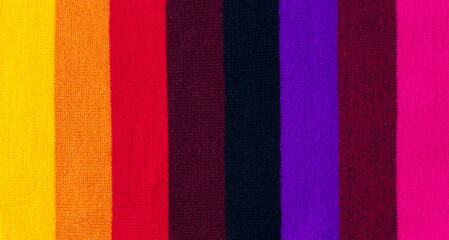 Fototapeta premium multi colored background. knitted wool fabric texture with stripes