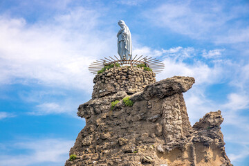 White statue of the Virgin Mary on the Rocher de la Vierge rock in Biarritz, France - obrazy, fototapety, plakaty