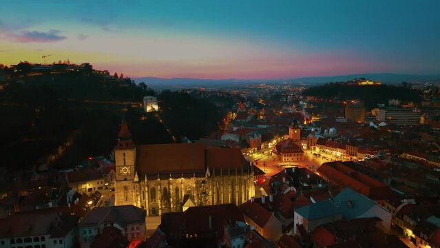 Drone video of Brasov City center - Council Square or Piata Sfatului at night. Blue hour, 4K