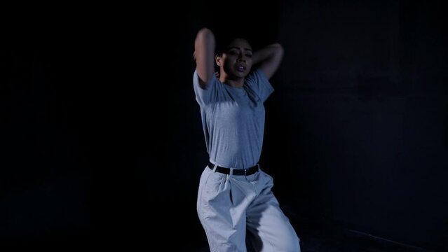 Young Latina in Gray Office Clothes Dancing Whacking Contemporary with Eye Contact