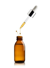 Cosmetic bottle of essential oil with pipette dripping oil