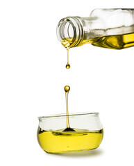 Olive oil bottle drippind oil on bowl on white background