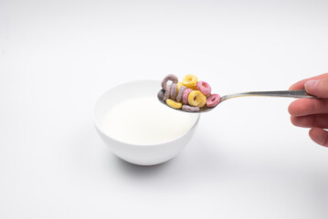 cornflakes. Oatmeal in a bowl. On the table, on a white background. The spoon
