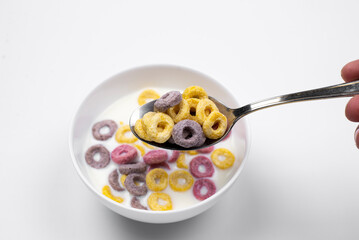 cornflakes. Oatmeal in a bowl. On the table, on a white background. The spoon
