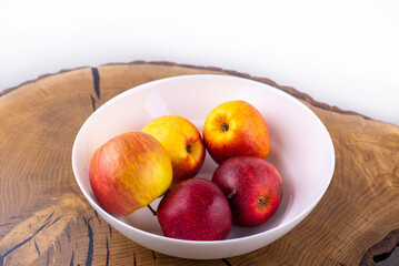 Red apples. Apples in a plate on a wooden table. Fruits