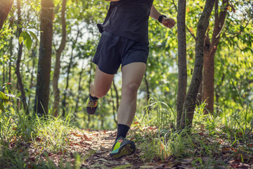 Woman runner running on forest trail