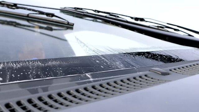 Wiper blades work when cleaning a car's windshield.
