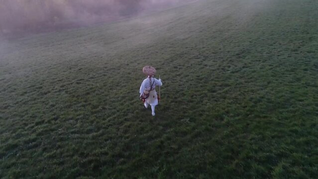 European buddhist shugendo monk walks in sunrise and fog and makes ceremony in nature