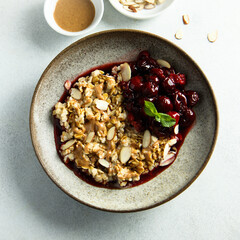 Healthy oatmeal porridge with cherries and almond