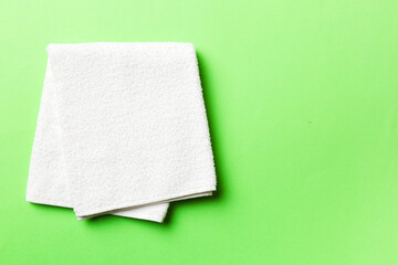 Top view of white towels with copy space on colored background