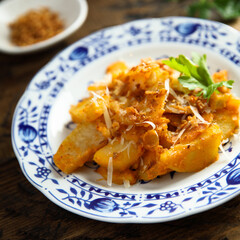 Roasted potato with red pesto and cheese