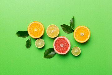 Fruit background. Colorful fresh fruits on colored table. Orange, lemon, grapefruit Space for text healthy concept. Flat lay, top view, copy space