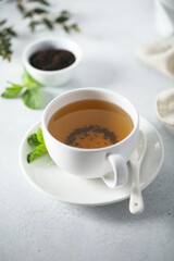 Healthy homemade mint tea in a white cup
