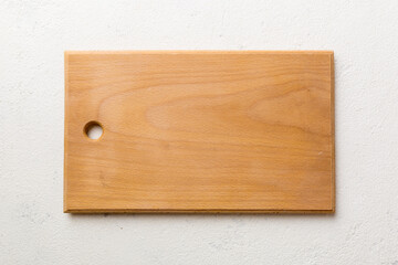 Top view of wooden cutting board on cement background. Empty space for your design