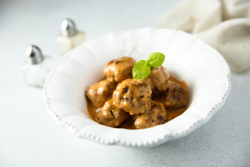 Homemade meatballs in a white bowl